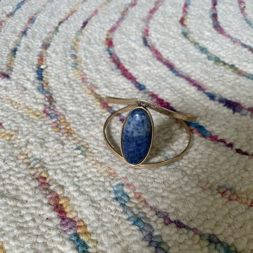 Adjustable gold bracelet with blue stone